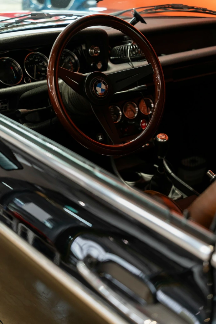 the interior of a car with a steering wheel and dashboard